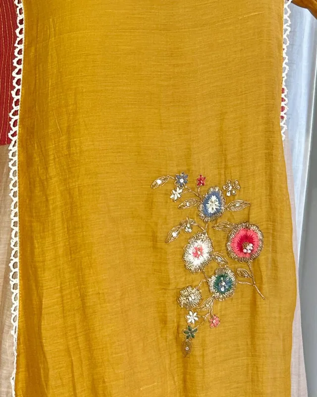 Home Close-up of mustard mul chanderi with floral thread embroidery