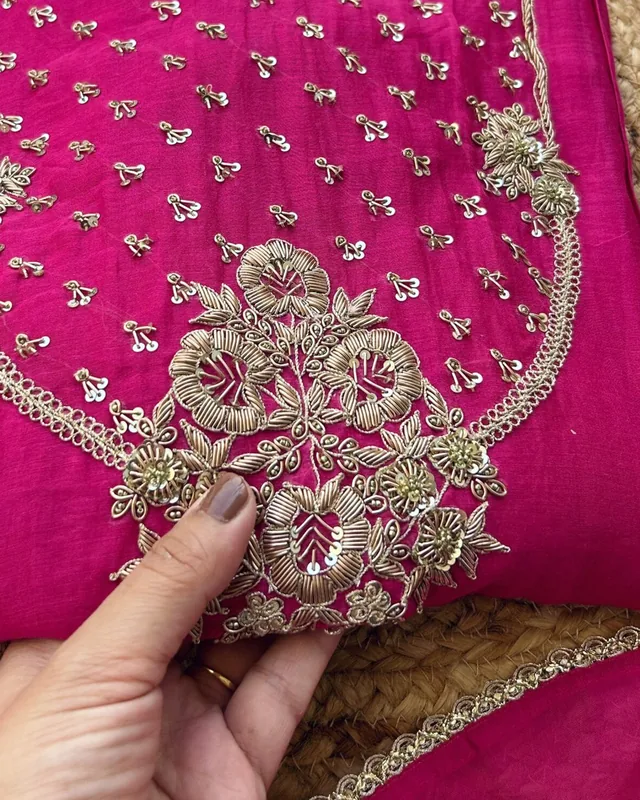 Home Close-up of zardozi hand embroidery on a magenta kurta